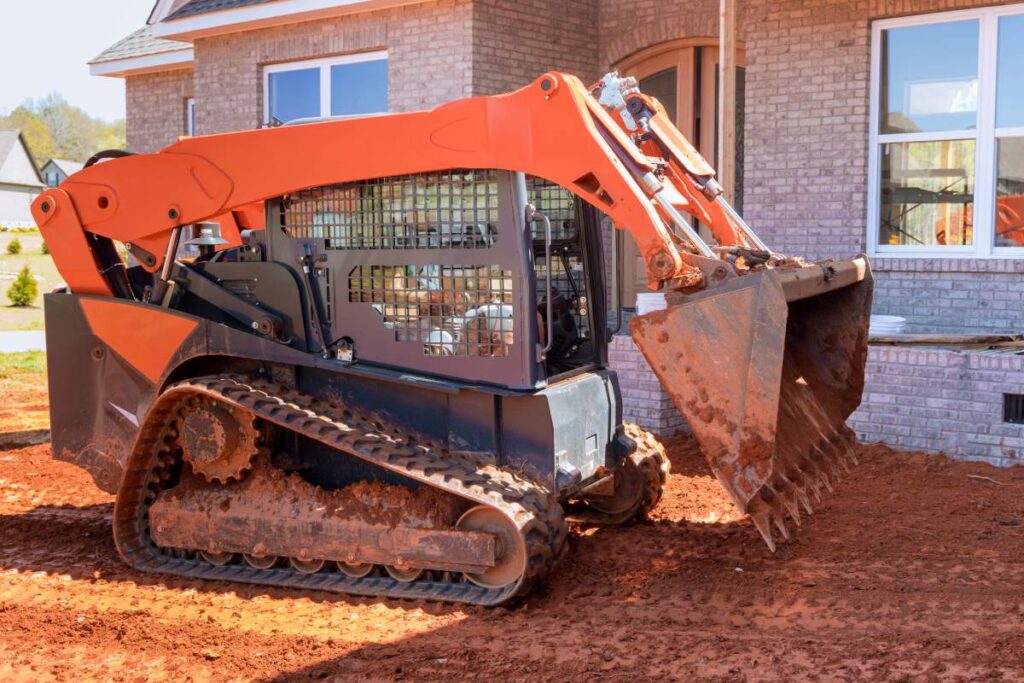 Mini bulldozer working with earth, moving soil doing landscaping works the territory improvement