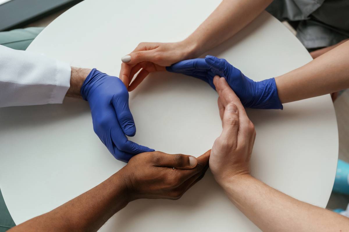 Circle shaped gesture. Group of doctors are holding hands in trust together