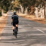 rear-view-of-professional-female-cyclist-riding-bi-2023-11-27-05-17-40-utc