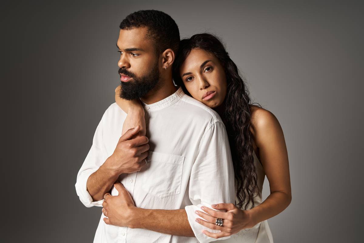 Relationships A fashionable couple stands together, exuding romance and intimacy in a contemporary space.
