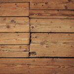 Old vintage rustic aged antique wooden sepia panel with horizontal gaps, planks and chinks with shaded border