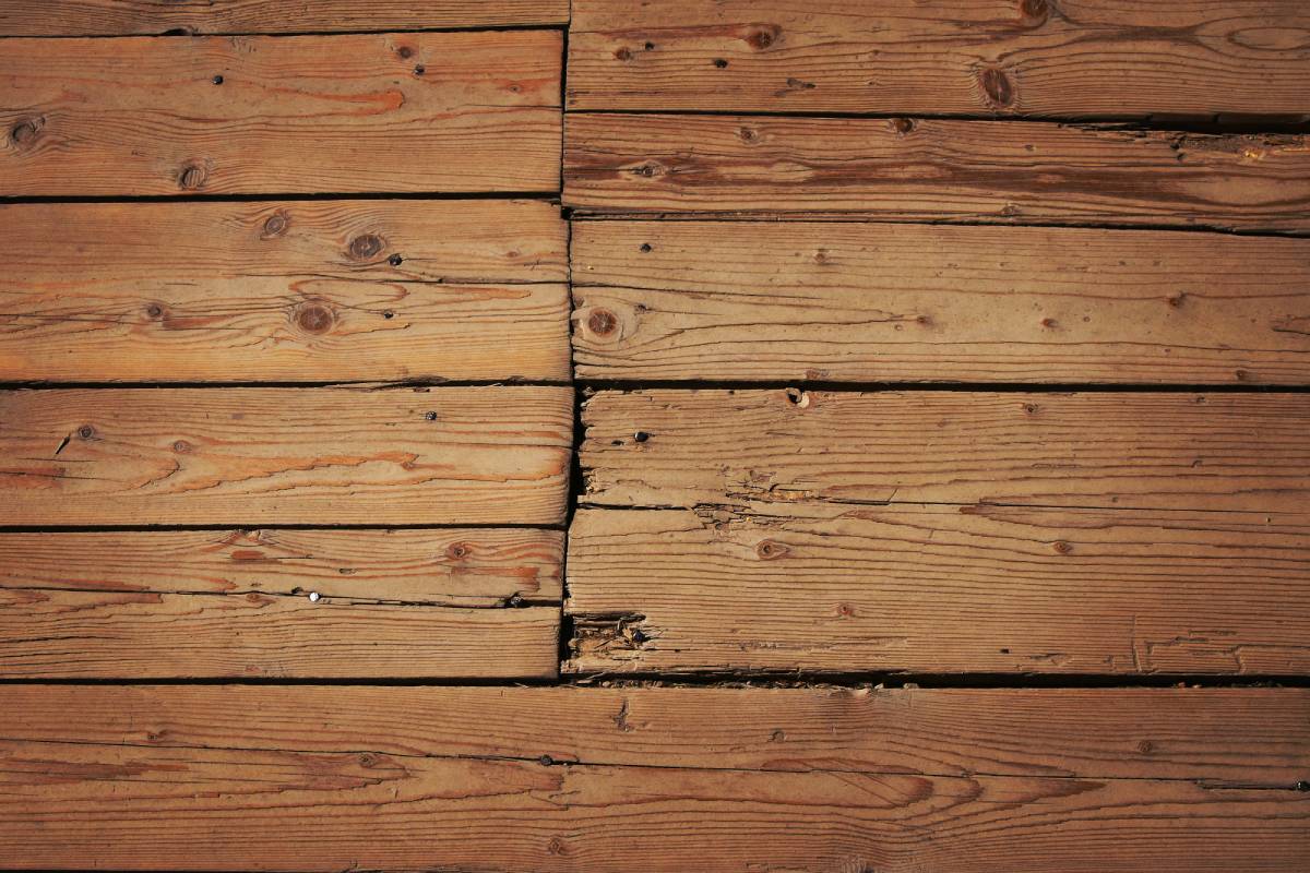 Old vintage rustic aged antique wooden sepia panel with horizontal gaps, planks and chinks with shaded border